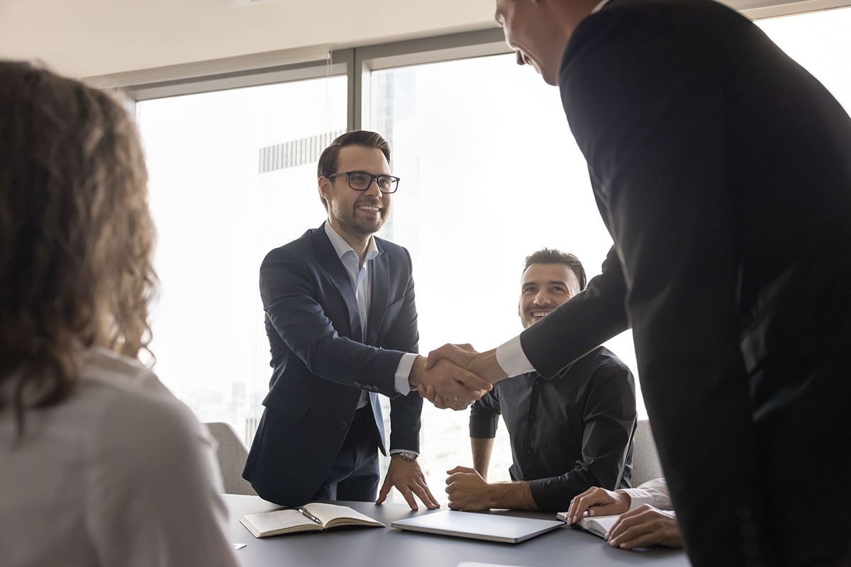 business man shaking hands with clients
